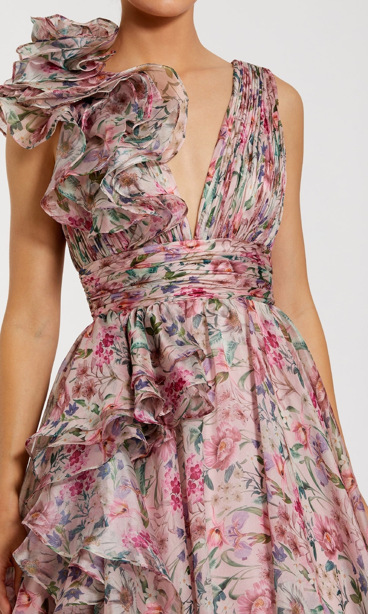 A woman wears the Mac Duggal 68947 Floral-Print Long Formal Dress, featuring a sleeveless deep V-neck, ruffled shoulders, and a pleated waist—ideal as a chiffon prom or formal gown.